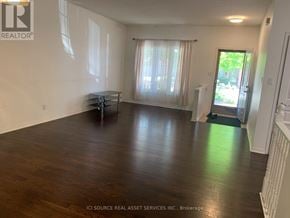 London North (North B) townhouse for rent - A room with wooden floors and white walls, furnished with a table and chairs.