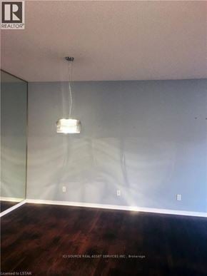 London North (North B) townhouse for rent - A room with a wooden floor and a light hanging from the ceiling.
