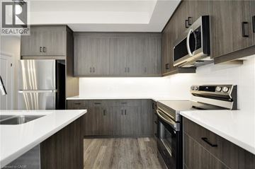 Cambridge townhouse for rent - A modern kitchen with wooden cabinets and stainless steel appliances.