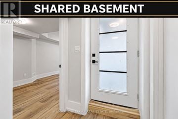 Toronto (East End-Danforth) triplex for rent - A white door with a glass window is in a room with wooden floors.