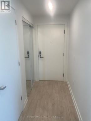 Milton (Cb Cobban) condo for rent - A hallway with a white door and a glass door.