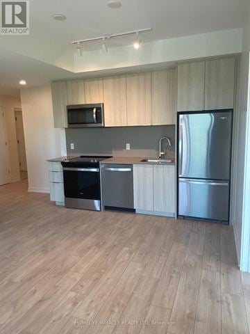 Milton (Cb Cobban) condo for rent - A kitchen with wooden floors and stainless steel appliances.
