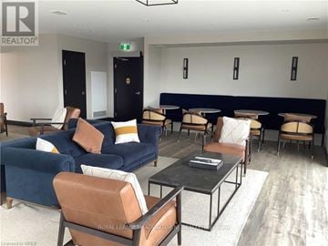 Cambridge condo for rent - A living room with a blue couch and brown chairs.