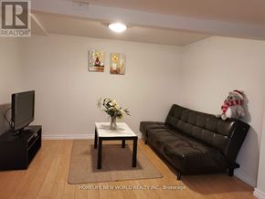 Toronto (Pleasant View) apartment for rent - A living room with a black leather couch, a coffee table, and a flat screen TV.