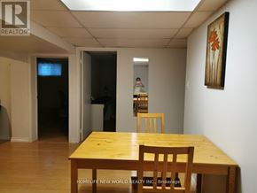 Toronto (Pleasant View) apartment for rent - A dining room with a wooden table and chairs.