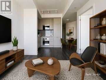 Markham (Unionville) condo for rent - A living room with a wooden coffee table and a black chair.