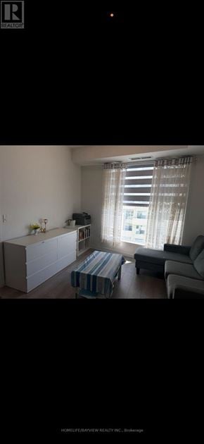 Vaughan (Concord) condo for rent - A living room with a couch, a coffee table, and a television.