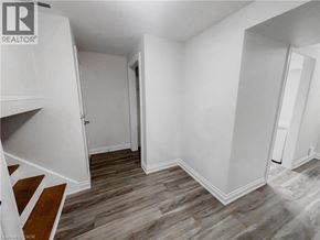 Kitchener apartment for rent - A room with wood flooring and white walls.