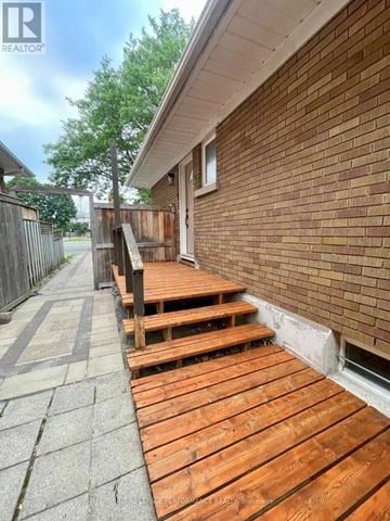 Ottawa apartment for rent - A wooden deck is in front of a brick building.
