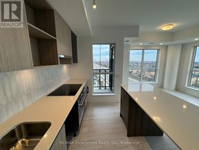 Oakville (Go Glenorchy) condo for rent - A modern kitchen with a view of the city.