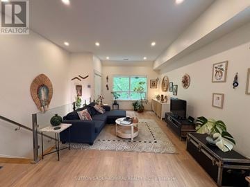 Toronto (Oakwood Village) apartment for rent - A living room with a dark blue couch and a wooden floor.