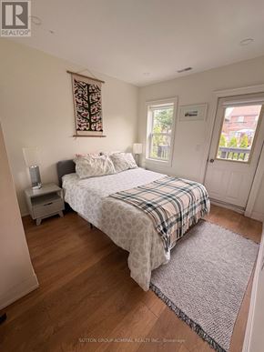 Toronto (Oakwood Village) apartment for rent - A bedroom with a bed, nightstand, and window.