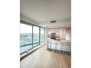 White Rock apartment for rent - A kitchen with a marble countertop and bar stools.