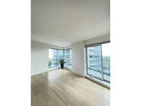 White Rock apartment for rent - A room with wooden floors and a large window overlooking a cityscape.