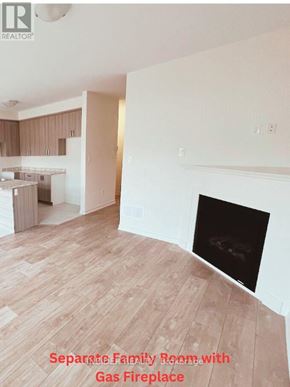 Centre Wellington (Fergus) apartment for rent - A kitchen with a bar stool and a table with a vase of flowers on it.
