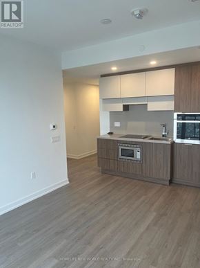 Toronto (Mount Pleasant West) condo for rent - A modern kitchen with wooden cabinets and a built-in oven.