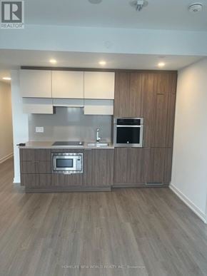 Toronto (Mount Pleasant West) condo for rent - A modern kitchen with wooden cabinets and stainless steel appliances.