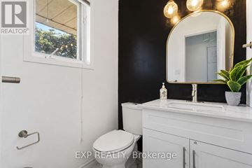 Clarington (Courtice) apartment for rent - A bathroom with a toilet, sink, and mirror.