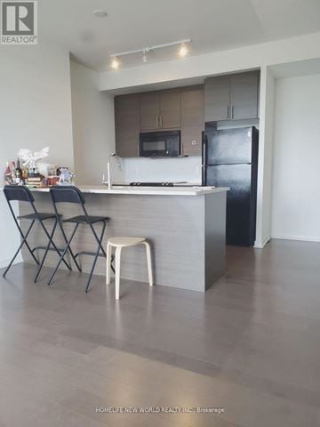 Toronto (Henry Farm) condo for rent - A kitchen with a bar stool and two chairs.