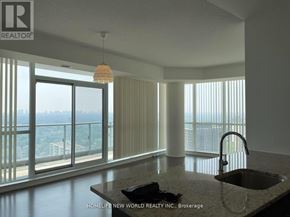 Toronto (Henry Farm) condo for rent - A modern kitchen with a large window overlooking a cityscape.