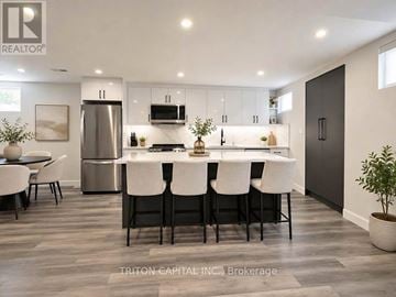 Vaughan (Kleinburg) apartment for rent - A modern kitchen with a dining table and chairs.