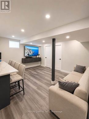 Vaughan (Kleinburg) apartment for rent - A living room with a couch, a television, and a table.