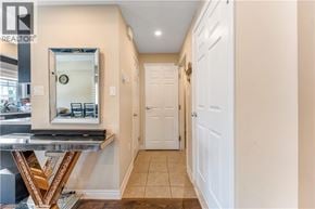 Kitchener townhouse for rent - A hallway with a mirror and a door.