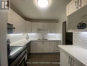 Toronto (Ionview) condo for rent - A kitchen with white cabinets and a stainless steel oven.