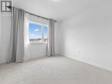 Kitchener apartment for rent - A room with a large window and curtains.