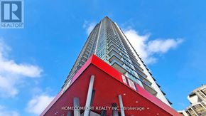 Toronto (Willowdale East) condo for rent - A tall building with a red and white facade and Home Comfort Realty Inc. Brokerage written on it.