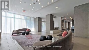 Toronto (Willowdale East) condo for rent - A spacious living room with a large couch and a rug.