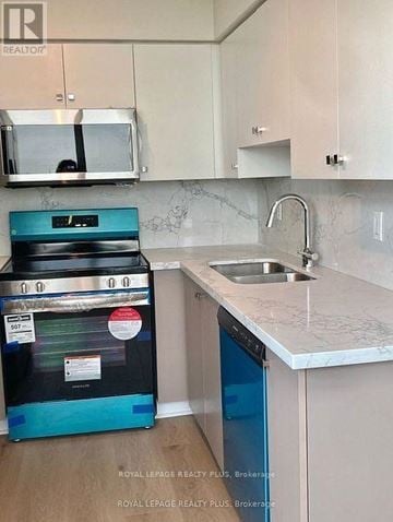 Vaughan (Crestwood-Springfarm-Yorkhill) condo for rent - A kitchen with a black oven and a blue dishwasher.
