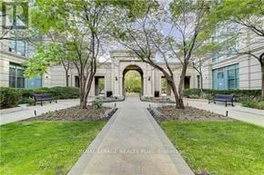 Vaughan (Crestwood-Springfarm-Yorkhill) condo for rent - A pathway leads to a building entrance surrounded by trees.