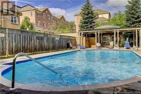 Vaughan (Crestwood-Springfarm-Yorkhill) condo for rent - A swimming pool in a backyard with a house in the background.