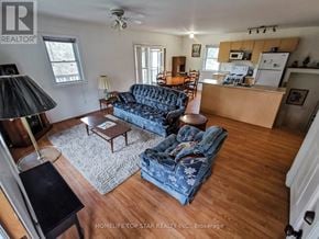Marmora And Lake (Marmora Ward) apartment for rent - A living room with a blue couch and a wooden floor.