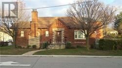 Toronto (Bedford Park-Nortown) apartment for rent - A red brick house with a tree in front.