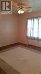 Toronto (Bedford Park-Nortown) apartment for rent - A room with a ceiling fan and a window with curtains.