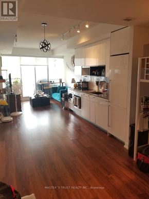 Toronto (Bayview Village) condo for rent - A kitchen with white cabinets and a wooden floor.