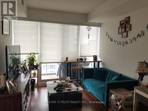 Toronto (Bayview Village) condo for rent - A living room with a couch, coffee table, and a window with blinds.