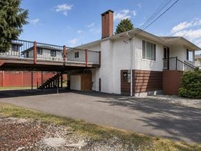 Delta apartment for rent - A house with a white exterior and a red fence.