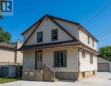 Hamilton apartment for rent - A two-story house with a garage on the side.