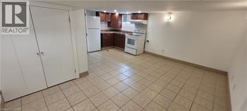 Hamilton apartment for rent - A kitchen area with a white refrigerator and cabinets.
