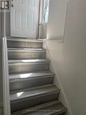Toronto (Clairlea-Birchmount) apartment for rent - A set of stairs leading up to a white door.