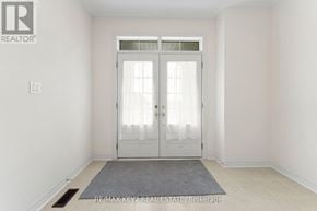 Richmond Hill apartment for rent - A white door with a glass window is in the middle of a room with a grey rug on the floor.