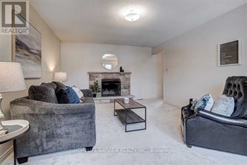 Newmarket (Bristol-London) apartment for rent - A living room with a grey couch, a fireplace, and a painting on the wall.