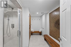 Sudbury apartment for rent - A modern bathroom with a walk-in shower and a bench.
