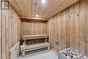 Sudbury apartment for rent - A wooden sauna with a bench and rocks.