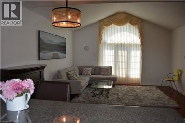 Waterloo house for rent - A living room with a grey couch and a painting on the wall.