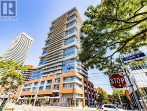 Toronto (Church-Yonge Corridor) condo for rent - A tall building with a blue sky in the background.