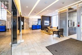 Toronto (Church-Yonge Corridor) condo for rent - A spacious living room with a grey rug, a black chair, and a television.